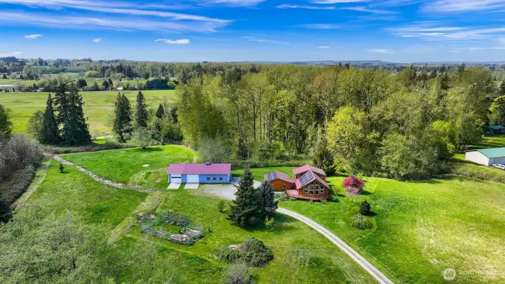The house sits right in the center of the property. There is a fenced garden area and plenty of room for an ADU.