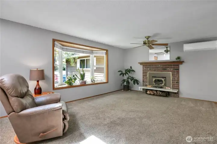 Bright bay window. Ceiling fan, woodburning stove and mini-split offer year round comfort.