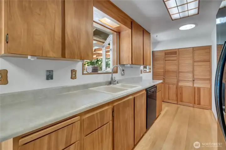 Gleaming cabinets, garden window, double sink and lots of counter space. Laundry hookup are in the closet.