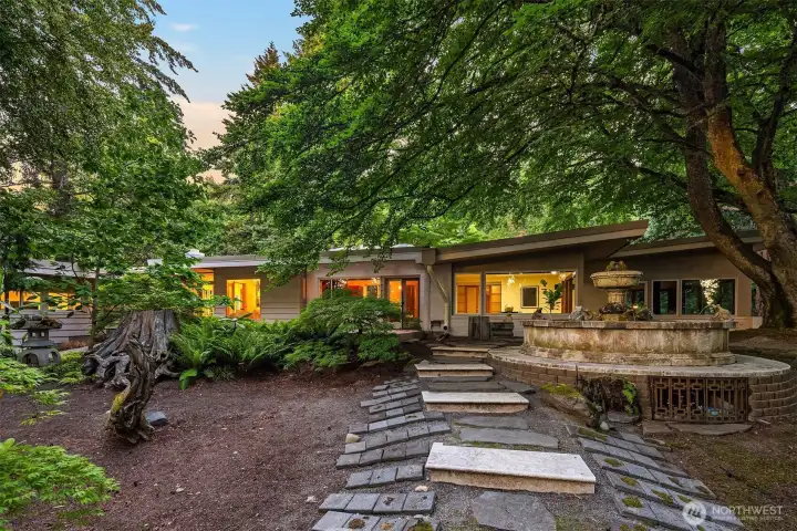 Nestled on a private 3/4-acre natural sanctuary, rests this 4400 square foot Mid Century Modern rambler.