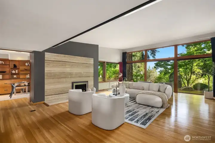 The sizable living room flows into the natural surroundings through glass walls.