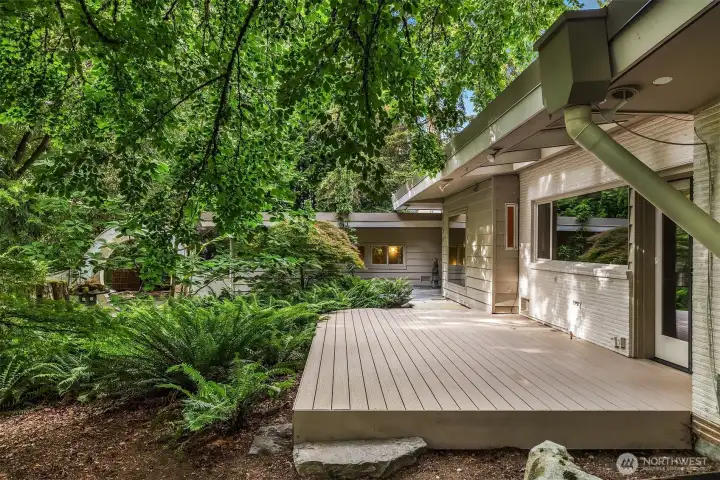 The house is fully open to the grounds leading to decks, patios and various garden rooms.