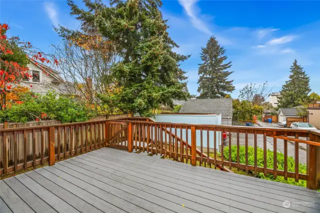 Deck off of kitchen with stairs that access the backyard.