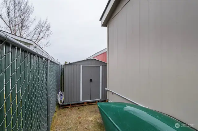 Metal storage shed stays with home.