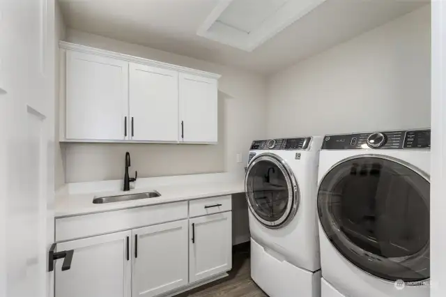 Large utility room with storage and sink.