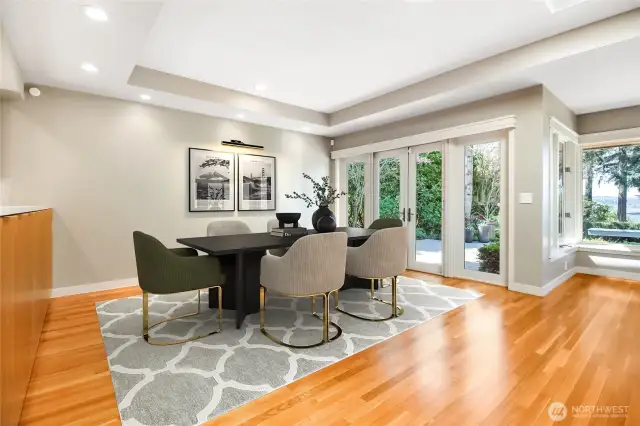 The dining room opens through elegant French doors to a private, west-facing patio—perfect for soaking in Lake Washington views and enjoying the surrounding low-maintenance, mature landscaping.