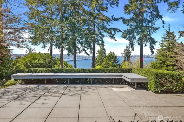 Savor sunny afternoons and sweeping Lake Washington views from your private, landscaped retreat—complete with charming bench seating nestled among the greenery.