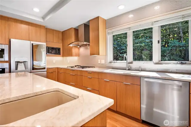 Featuring top-of-the-line Miele appliances, stunning stone countertops, and custom cabinetry, this kitchen blends function and style effortlessly.