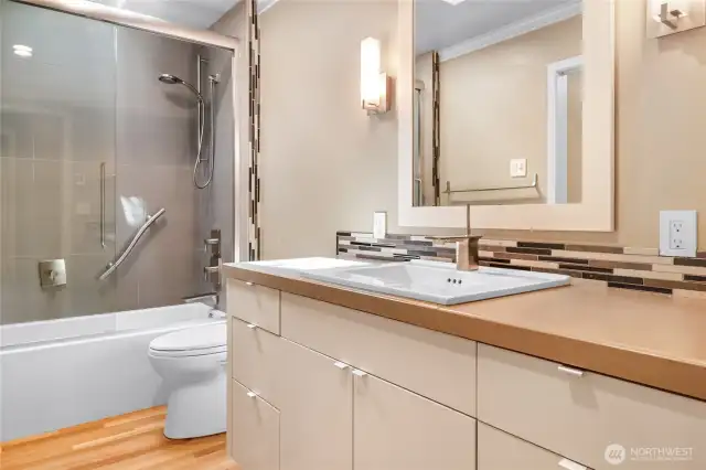 A Spacious Hallway Bathroom Featuring Elegant Tile Details
