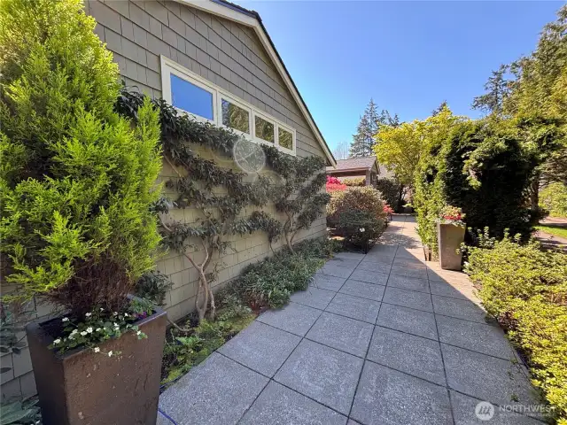 The entry walkways are beautifully framed by mature landscaping, perfectly complementing the natural surroundings and setting the tone for what lies beyond.