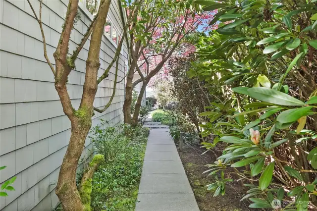 Meandering paths and vibrant gardens invite exploration, revealing delightful surprises at every turn, creating an enchanting experience throughout the property.