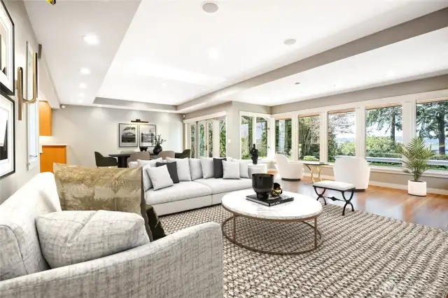 Bathed in natural light and framed by Western-facing views of Lake Washington, the living room is a masterpiece of warmth and elegance.