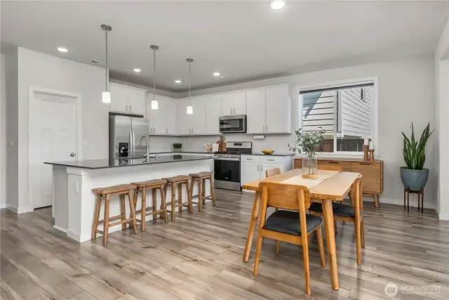 Kitchen flows to spacious dining area, perfectly situated between the kitchen and living room