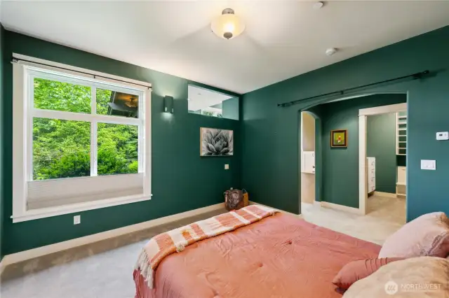 This is the main level primary bedroom. See the walk-in closet with built-in shelves and drawers adjacent.
