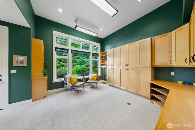 The studio is large, with more storage cabinets than you could ever fill. A built-in desk and its own exterior door.