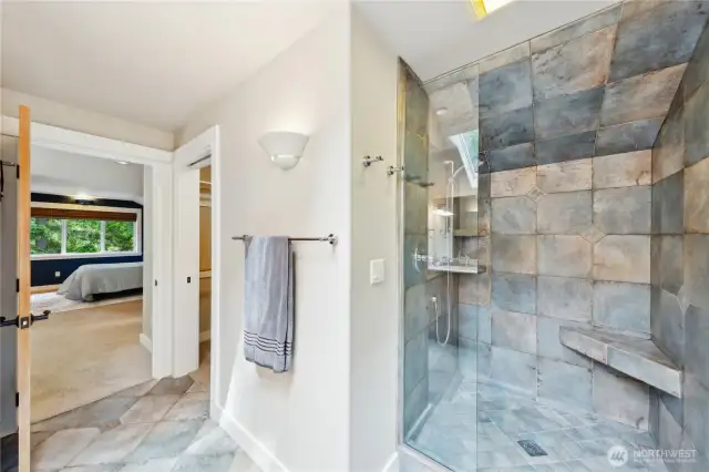 The loft level suite has a private tile shower with built-in seat. It also has a walk-in closet.