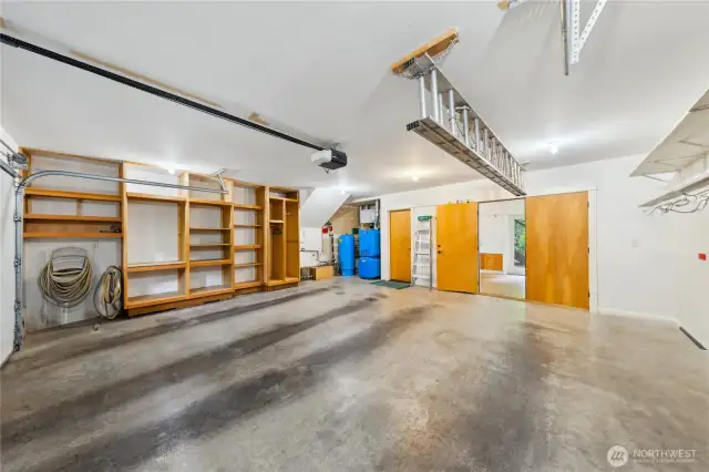 The two-car garage has its own built-in storage. See the radiant heat, water and air handling systems in blue. Center is the door to the workshop, and to the left of it, the door to the mudroom on the main level.