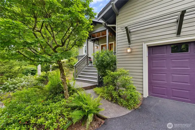 Access to the front entry deck, garage and driveways, softened by beautiful plantings.