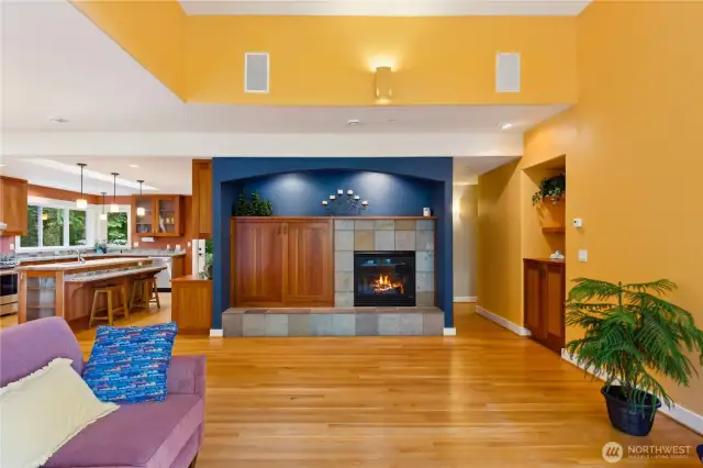 The living room has a gas fireplace with slate tile surround and custom cherry built-in entertainment cabinet.