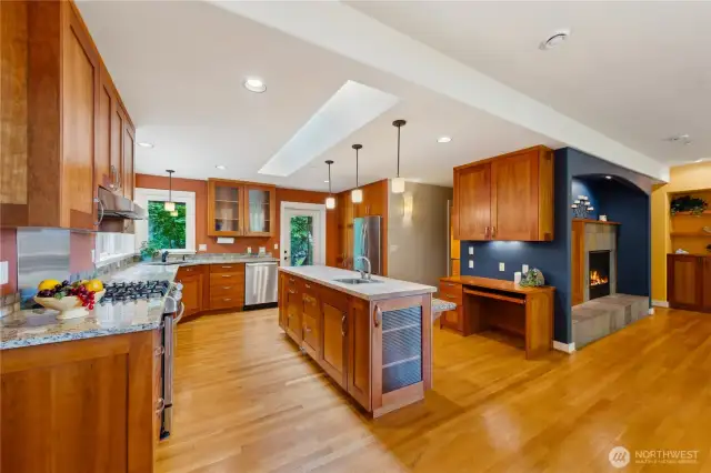 Kitchen with large butcher block island. Note expertly layered lighting. Can-lights, sconces, pendants, task lights.