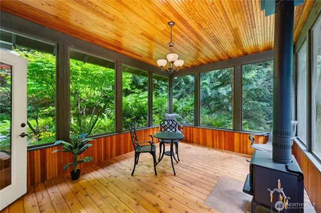Fully screened porch with solid wood floors, wainscoting, lighting; space for guests, or just a quiet place for two.