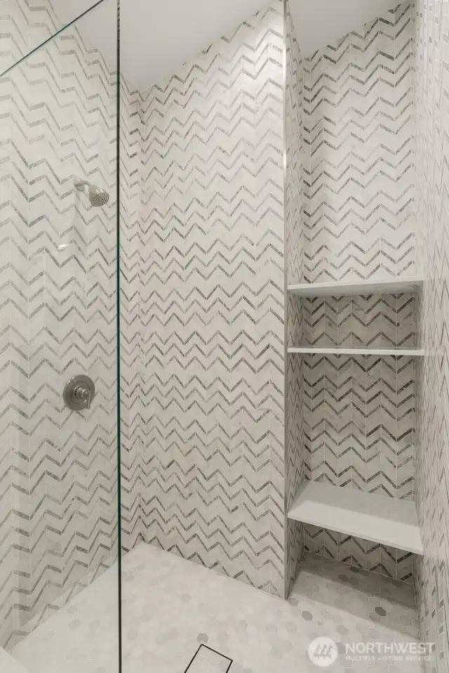 Marble Tile in the walk-in shower and floating glass.
