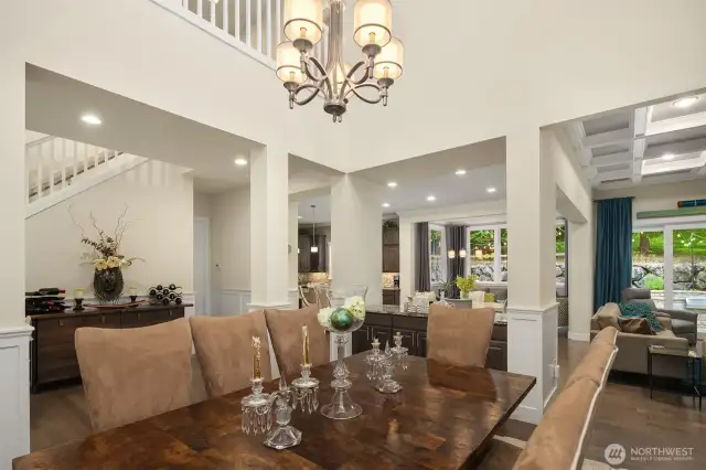 The dramatic dining room is the heart of the house, with soaring 23 foot ceilings open to the loft above.