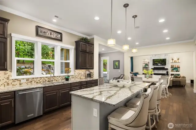The chef's kitchen has loads of counter and cabinet space and a huge kitchen island.