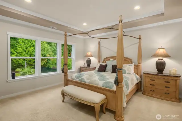 Beautiful ceiling detailing and a wall of windows looking out to your own private acreage grace this lovely space.