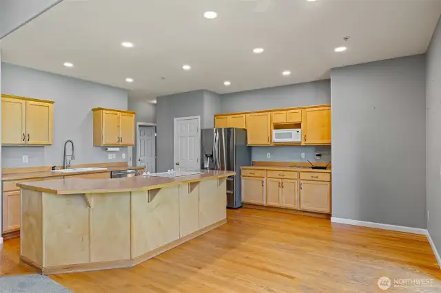 Open kitchen with breakfast nook and bar.