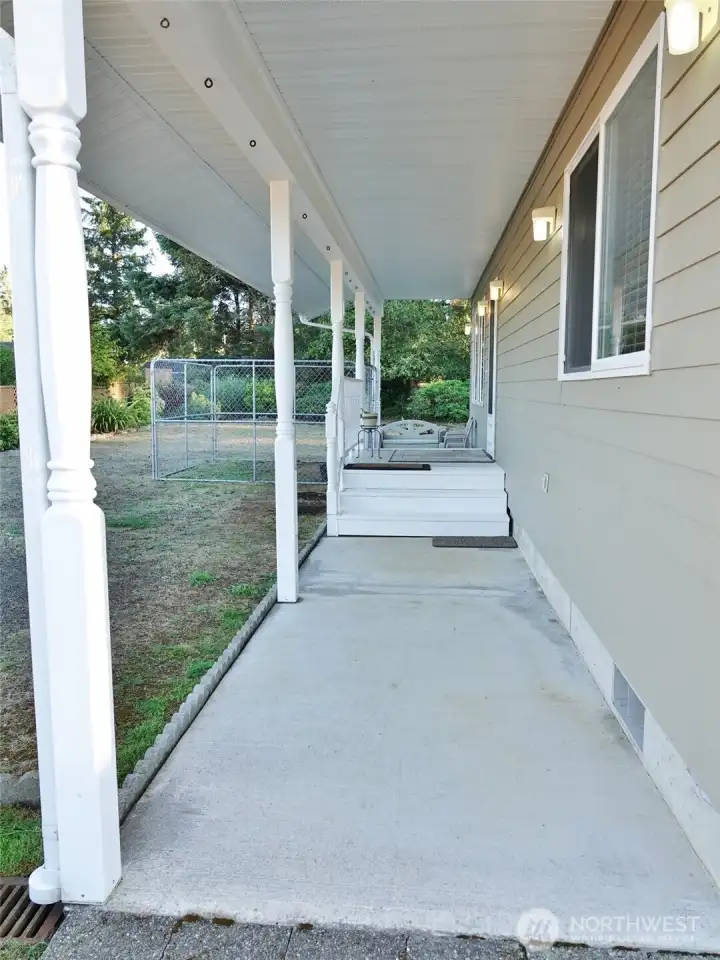 Covered concrete walkway leads to the Front Entry.
