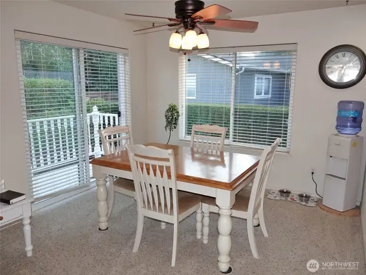 Dining Area w/ a ceiling fan and a slider to the Rear Deck and Backyard.