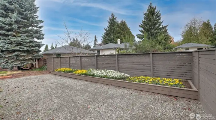 Large back yard wi8th raised garden or flower beds
