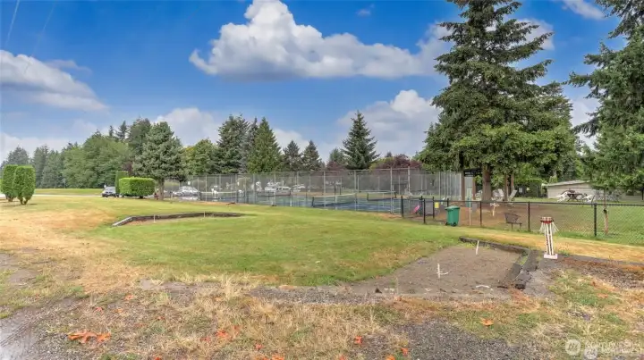 Horseshoe pit with secured RV parking in the background.