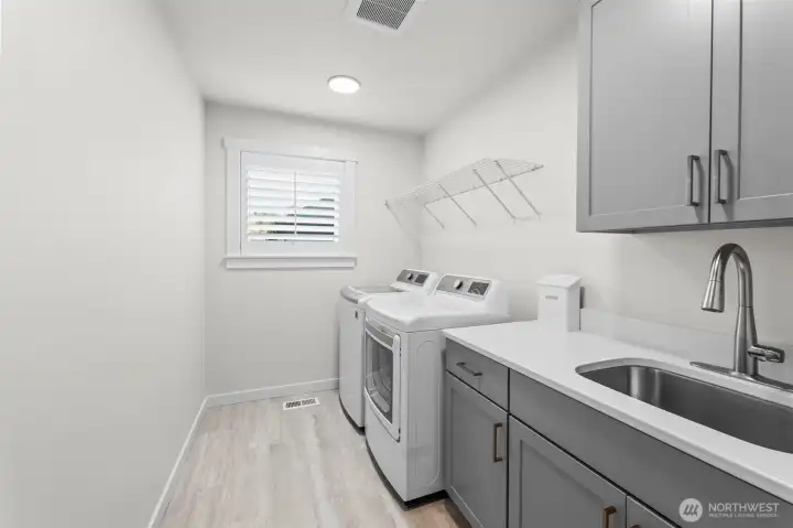 Laundry room with wash basin and extra storage.