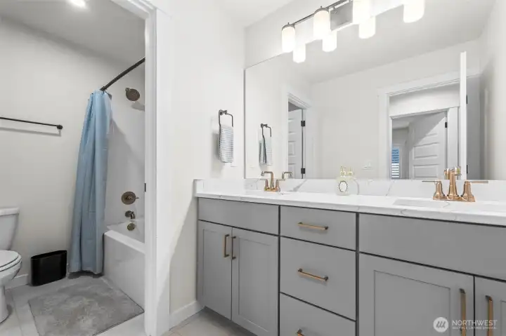 Upstairs guest bathroom with double vanity.