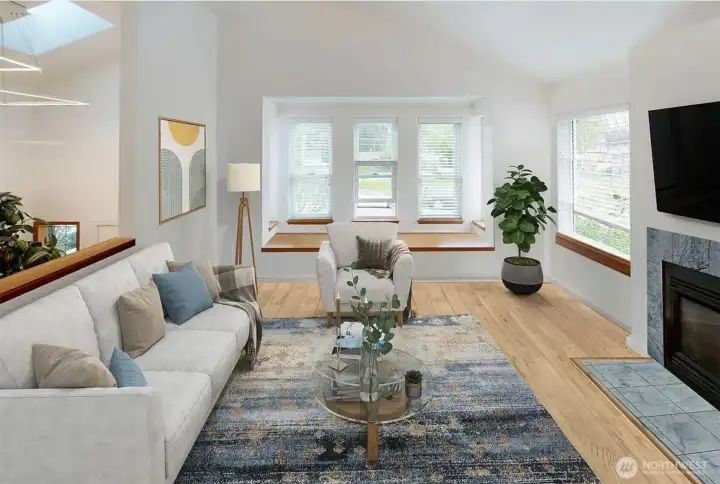 Living room has cathedral ceiling and built-in window seat (virtually staged)