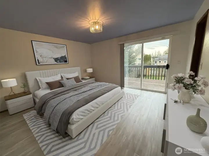 Primary bedroom with sliding doors to private deck and spiral staircase