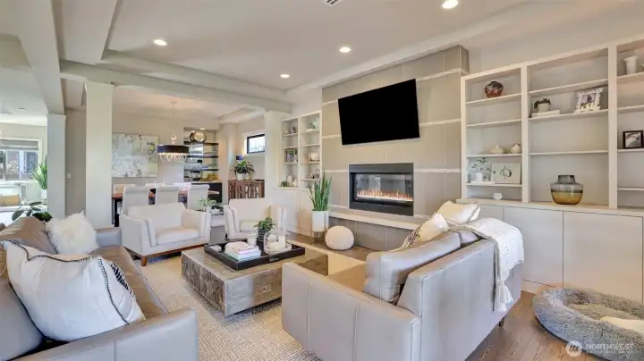 o Custom built-ins with shelves, media cabinet, accent lighting, and more.  o Open to Kitchen and Dining / Entertaining space with Wet Bar  o Featuring a modern, horizontal gas fireplace   o Look for the custom modern, glass art window that matches the style of the home