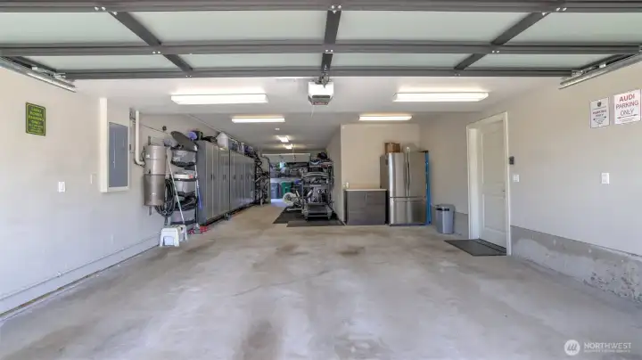 o Oversized three-car tandem garage.  o Partially finished shop area with lots of storage  o Covered patio with water and electrical behind the garage.  o The garage and shop are outfitted with Gladiator wall panels and slats to support a custom cabinet configuration. The buyer to provide the cabinets and accessories.