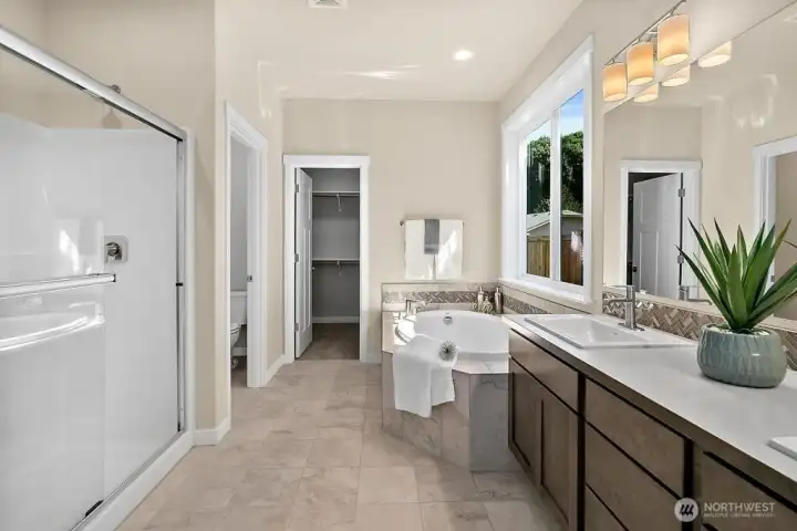Primary ensuite with soaking tub, quartz, double vanity and shower.