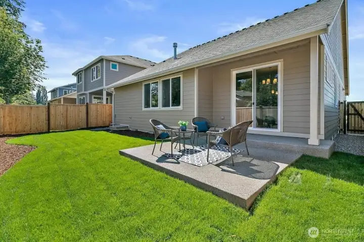 Covered back patio with fully fenced, landscaped yard.