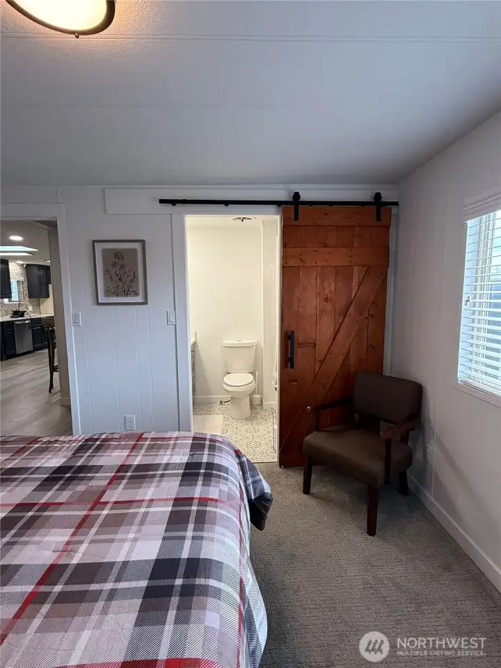 Reclaimed wood door to primary bath