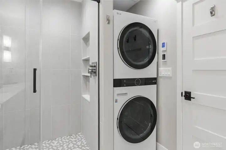 Stacked Washer and Electric Dryer. There is an Additional Stacked Washer and Gas Dryer in the Garage that remains with this Exceptional Home.