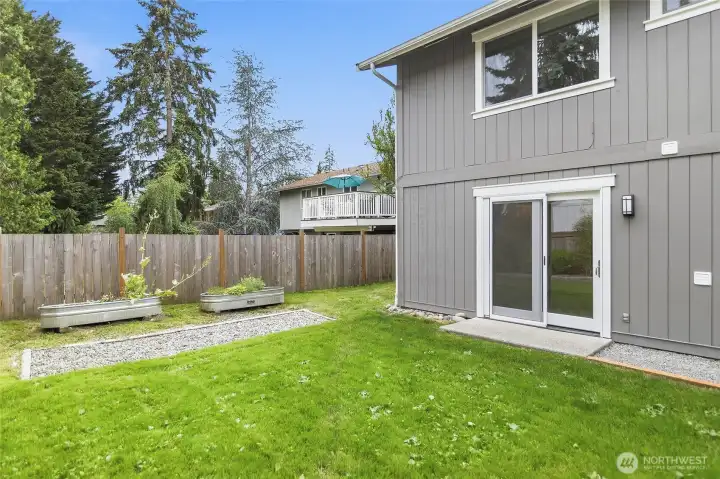 The Private Backyard is Accessed from the Deck, Family Room, and Two Side Gates.