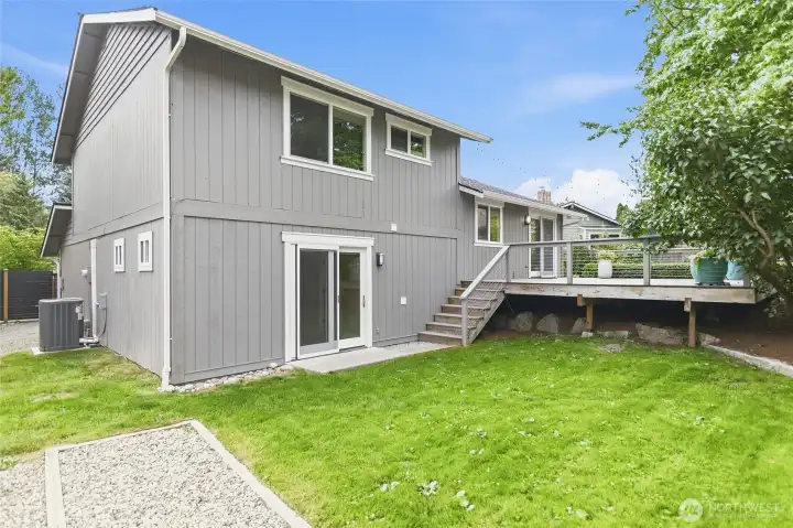 The Private Backyard is Accessed from the Deck, Family Room, and Two Side Gates.