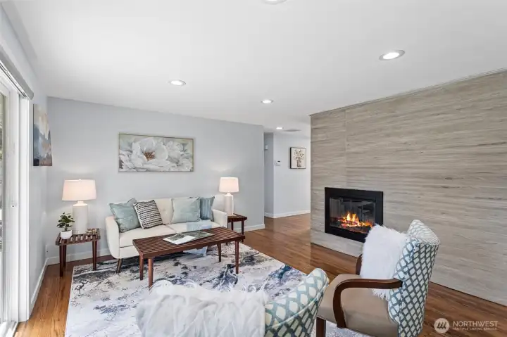 Floor-to-ceiling tile feature wall, wood-burning insert, slider to the backyard. January is covered.