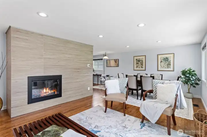 From the fireplace to the dining room — the main living zone reads as one continuous space.