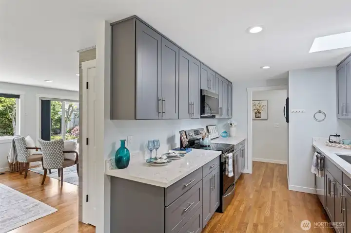 From here: breakfast nook, laundry, private bedroom wing, dining room, living room, and the backyard. The kitchen is the hub.