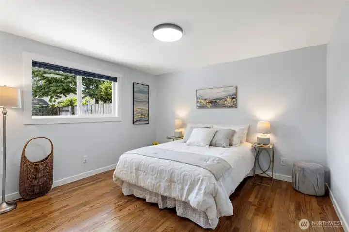 The southwest bedroom. Hardwood floors and a tree worth waking up to.